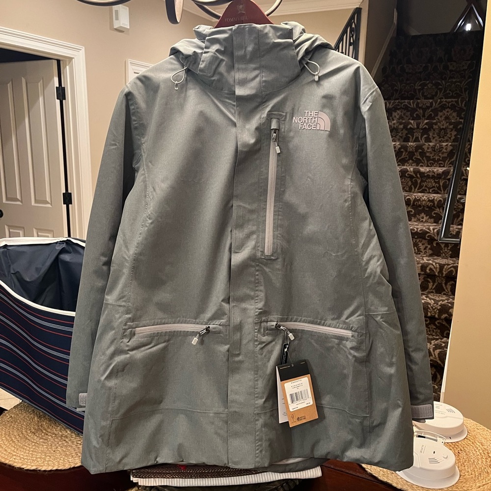 Brand new women’s grey North Face dry vent jacket with hood. Never worn!